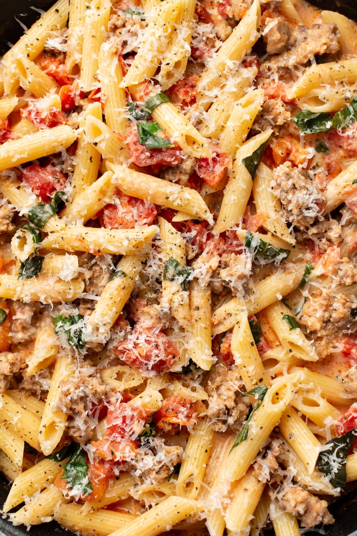closeup of a skillet with spicy italian sausage pasta