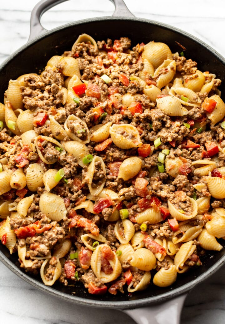 a skillet with cheesy taco pasta