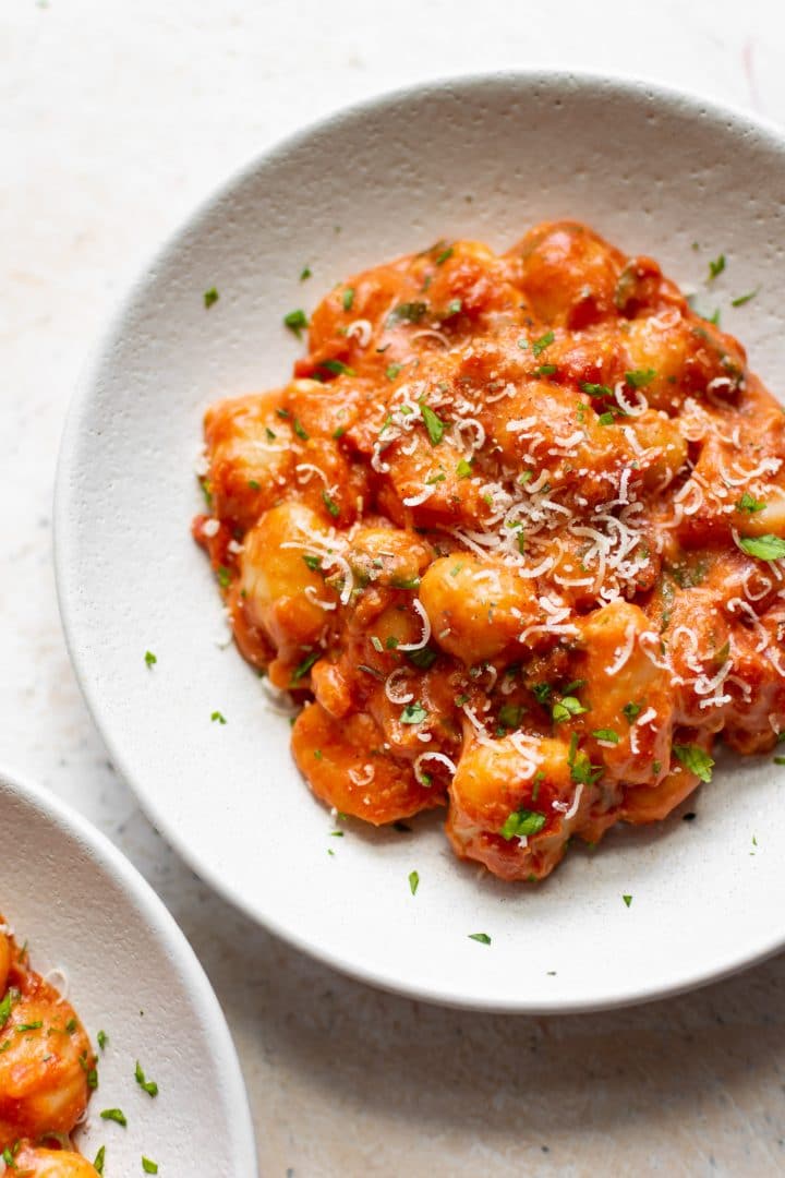 tomato gnocchi in two white bowls