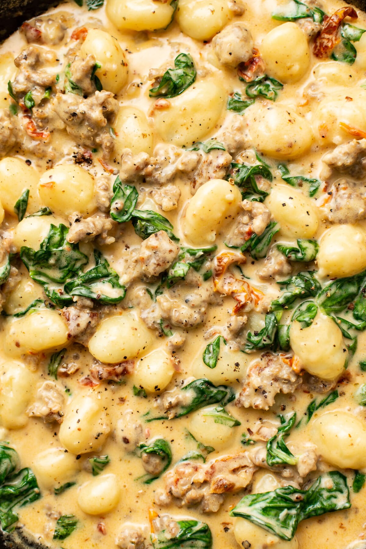 closeup of a skillet with creamy italian sausage gnocchi