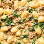 closeup of a skillet with creamy italian sausage gnocchi