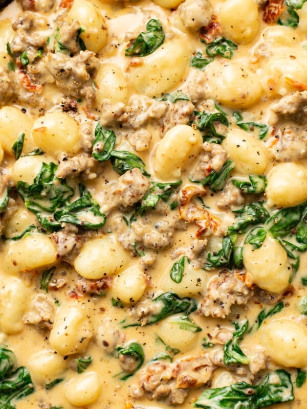 closeup of a skillet with creamy italian sausage gnocchi