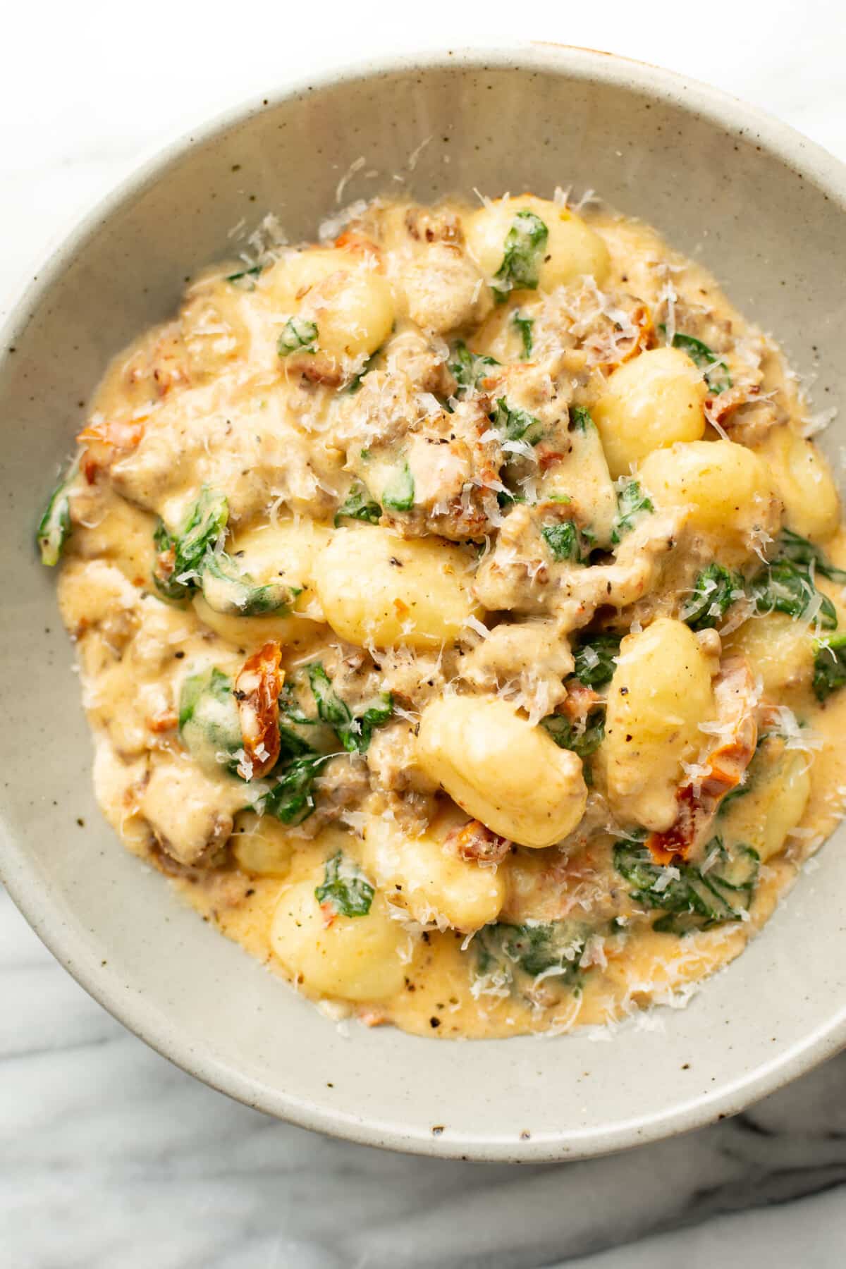 a bowl with tuscan sausage gnocchi and parmesan