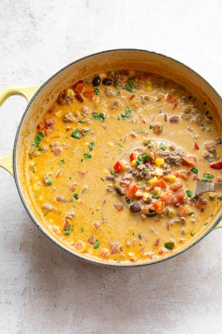 creamy beef taco soup in a yellow soup pot
