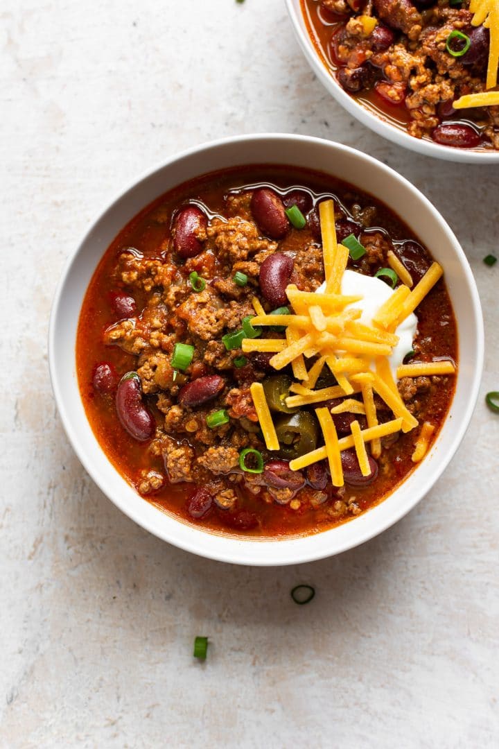 slow cooker ground beef chili in two white bowls
