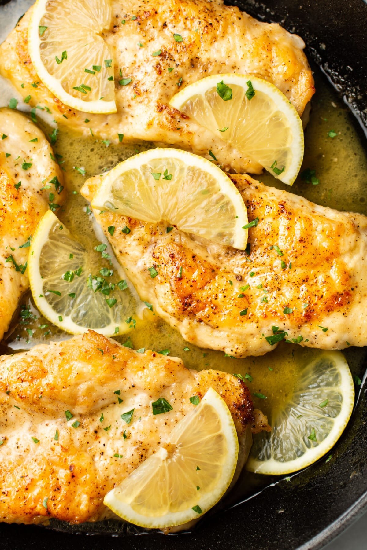 closeup of a skillet with honey lemon chicken