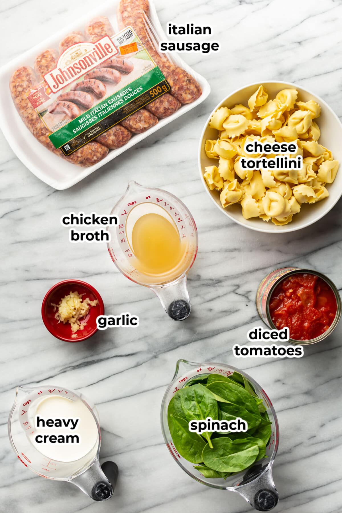 ingredients for tortellini with italian sausage in measuring cups and prep bowls