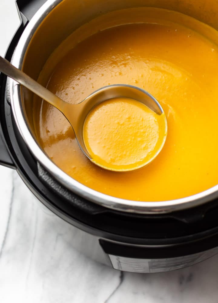 butternut squash soup in the Instant Pot with a ladle