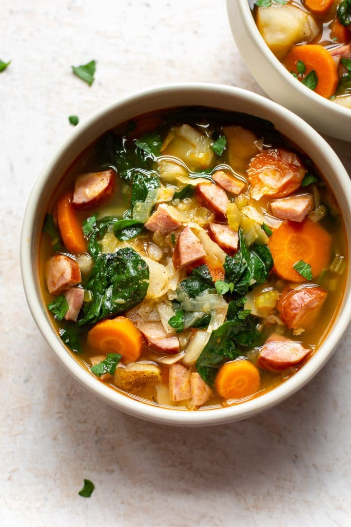 kielbasa cabbage soup in two bowls