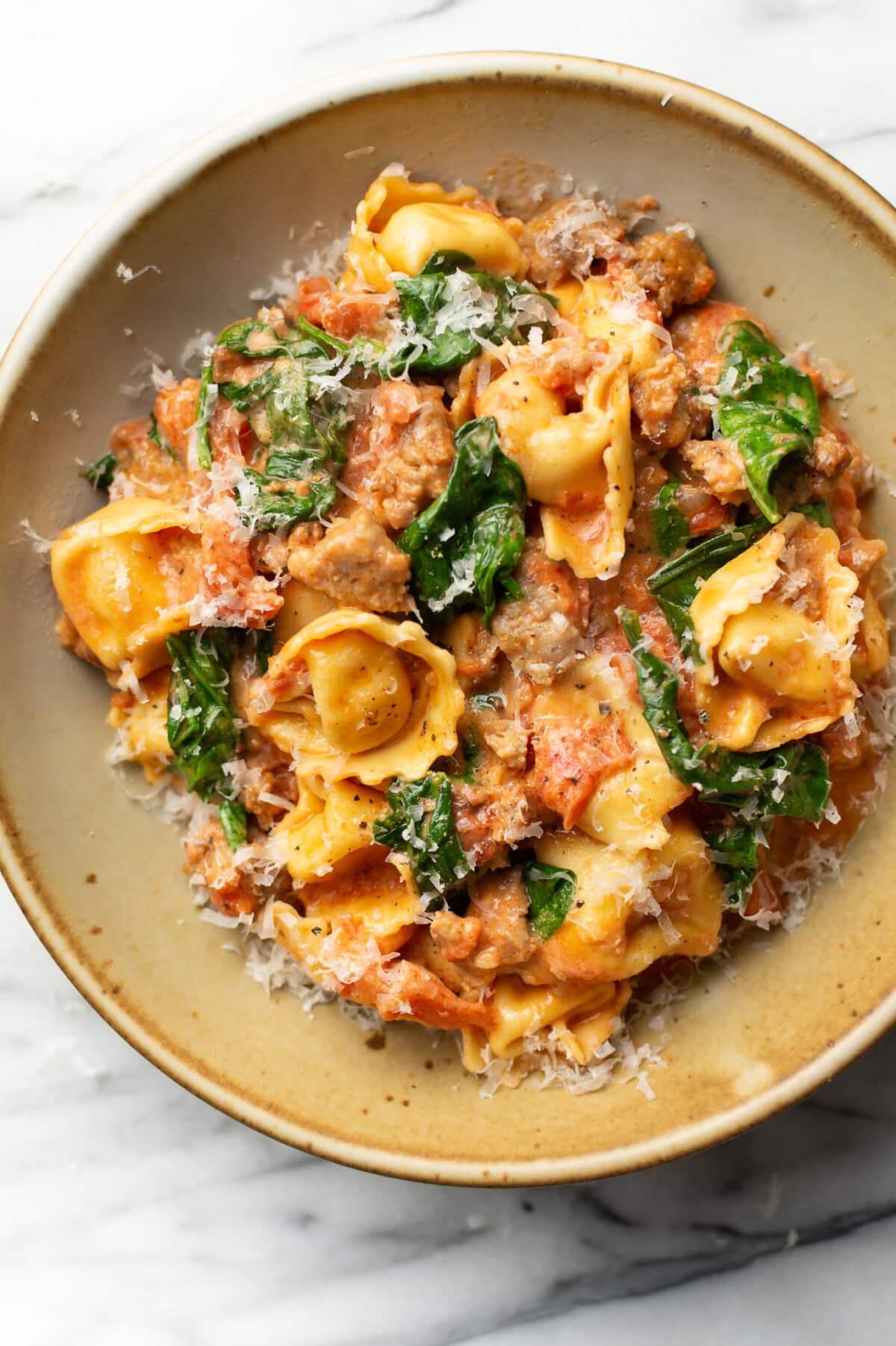 a bowl of italian sausage tortellini