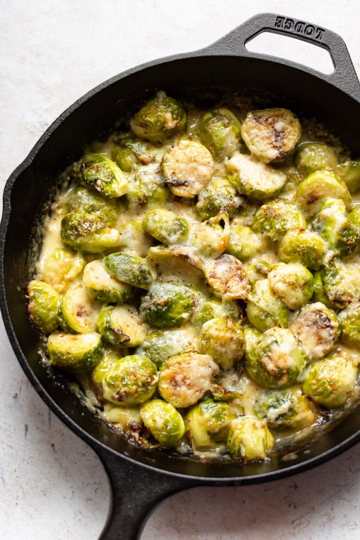 Brussels sprouts au gratin in a cast iron skillet