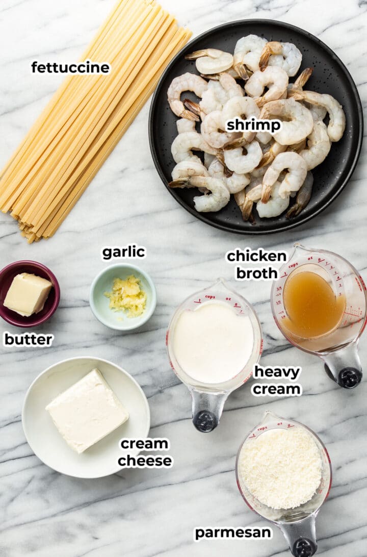 ingredients for shrimp alfredo in prep bowls