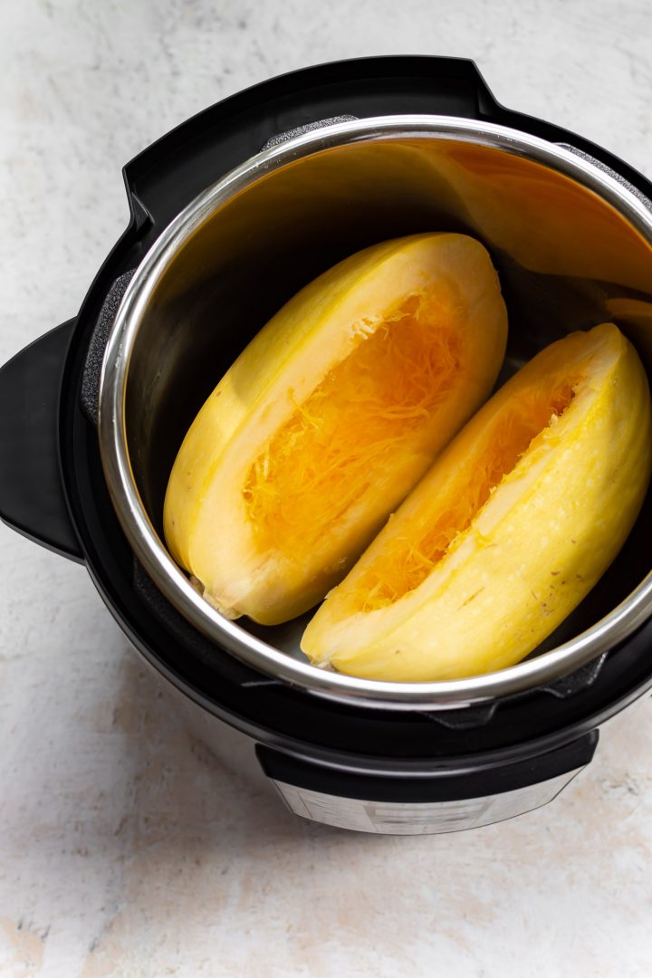 two spaghetti squash halves in an Instant Pot