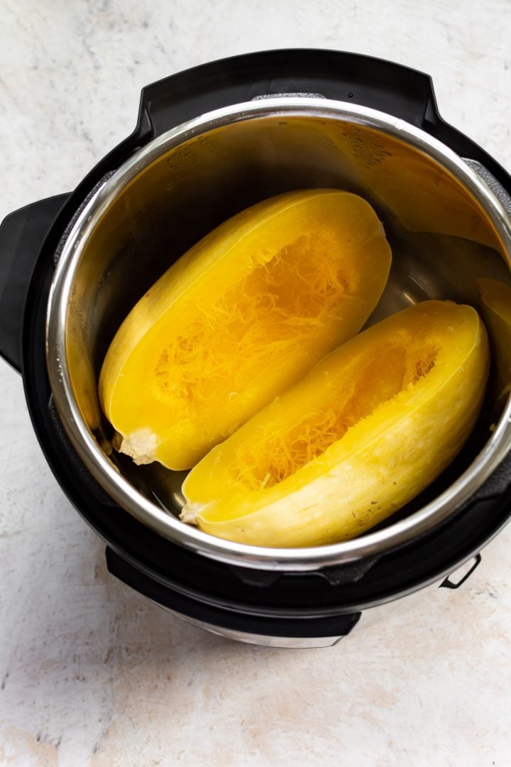 cooked spaghetti squash halves in an Instant Pot