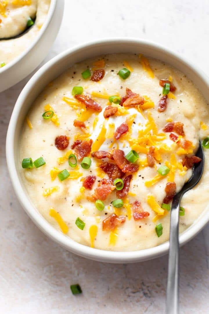 creamy loaded baked potato soup with a spoon