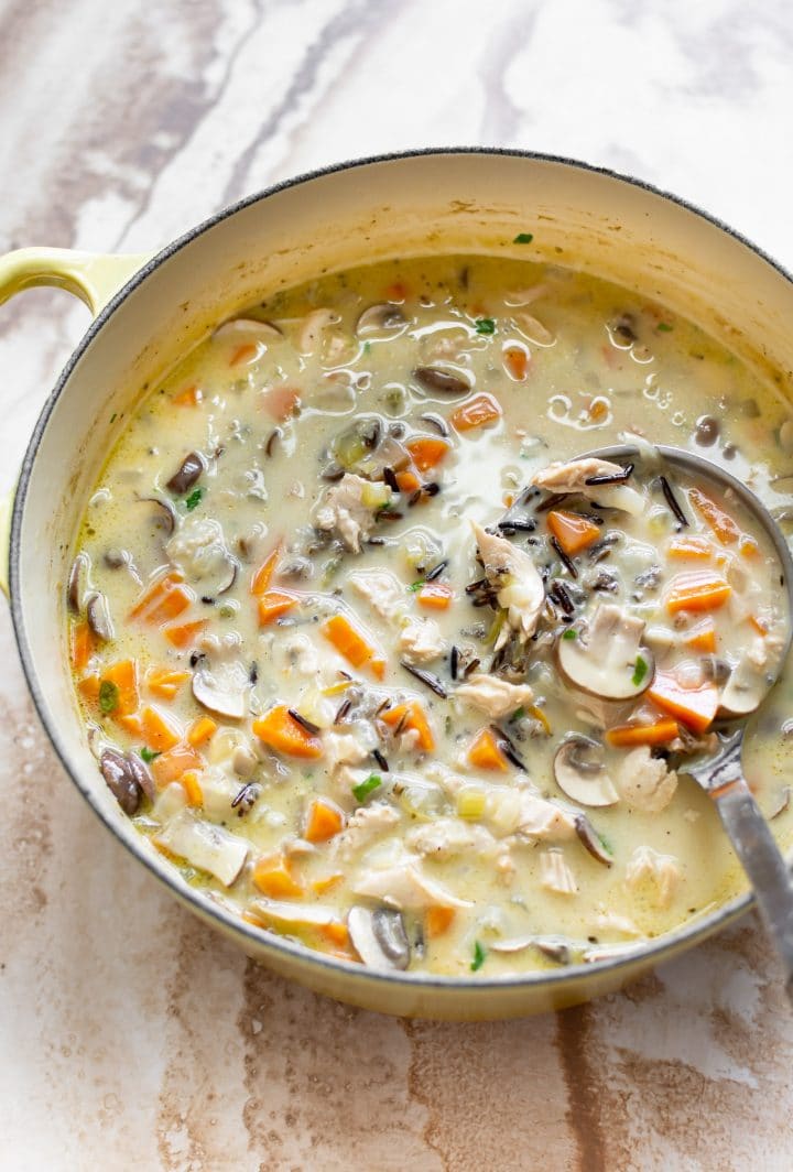 creamy turkey wild rice soup in a yellow soup pot