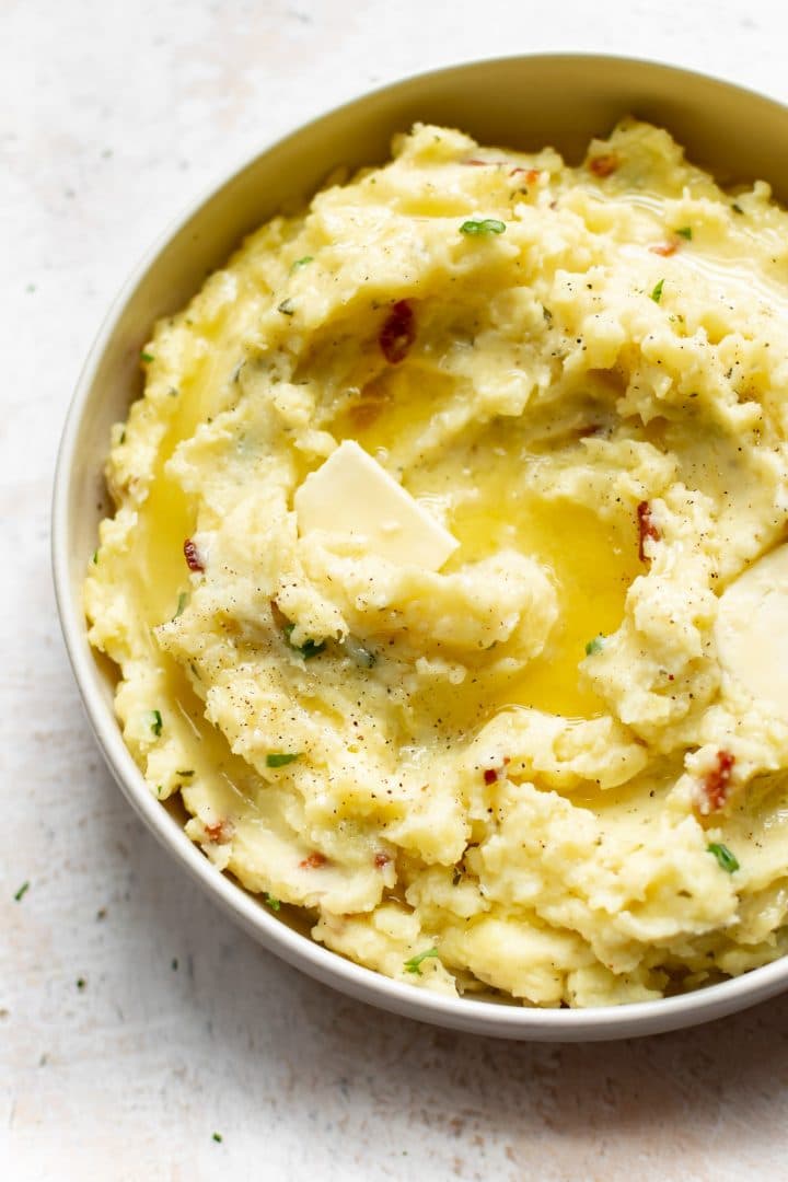 closeup of creamy ranch mashed potatoes with melted butter on top