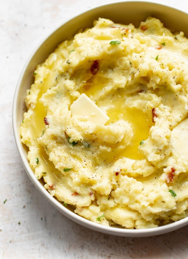 closeup of creamy ranch mashed potatoes with melted butter on top