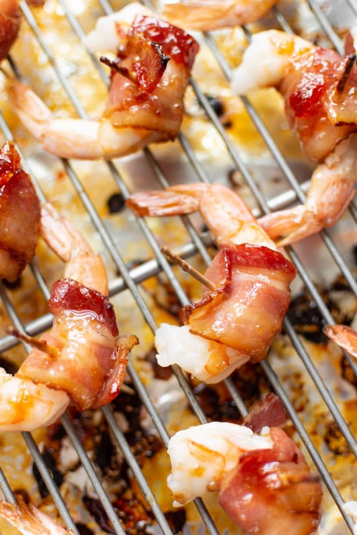 bacon-wrapped shrimp on baking sheet