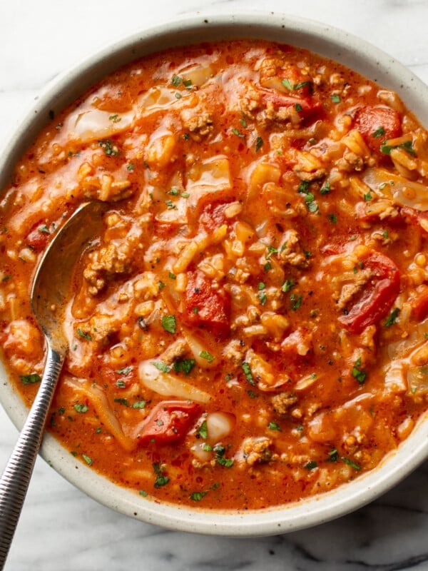 a bowl of cabbage roll soup with a spoon