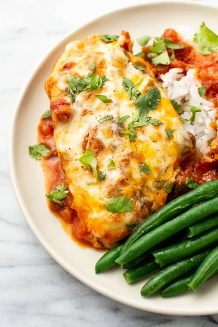 a plate with salsa chicken, rice, and green beans