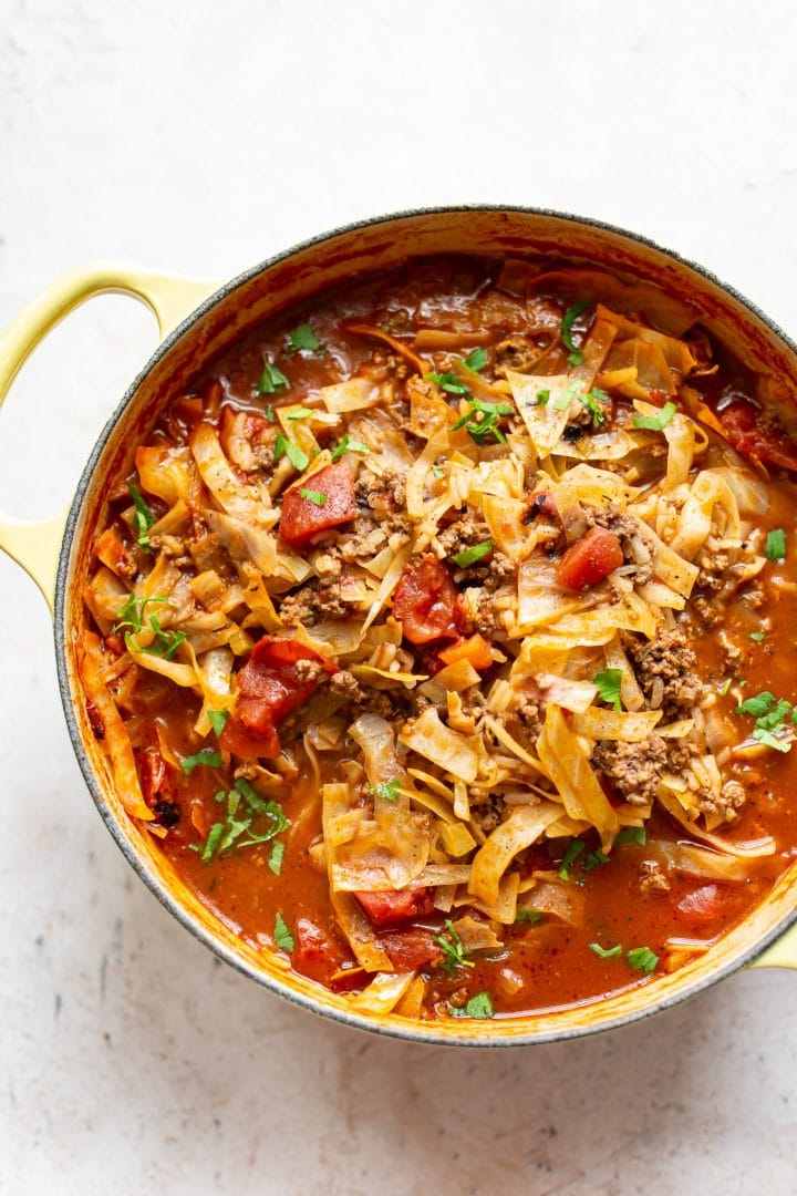 stuffed cabbage soup with rice in a yellow pot