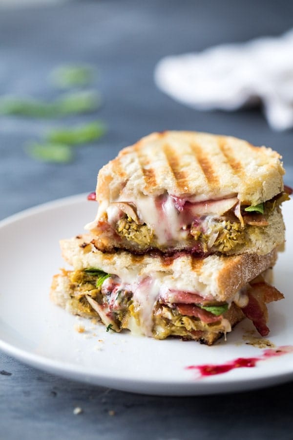 stacked turkey panini on a white plate