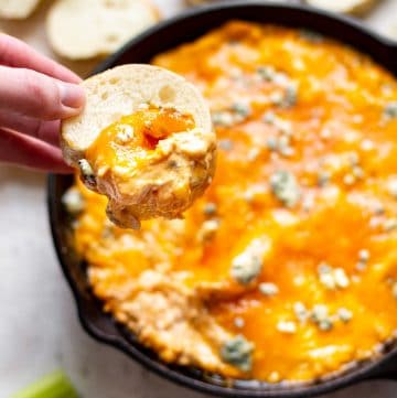 Frank's Red Hot buffalo chicken dip with a baguette scoop and melty cheese