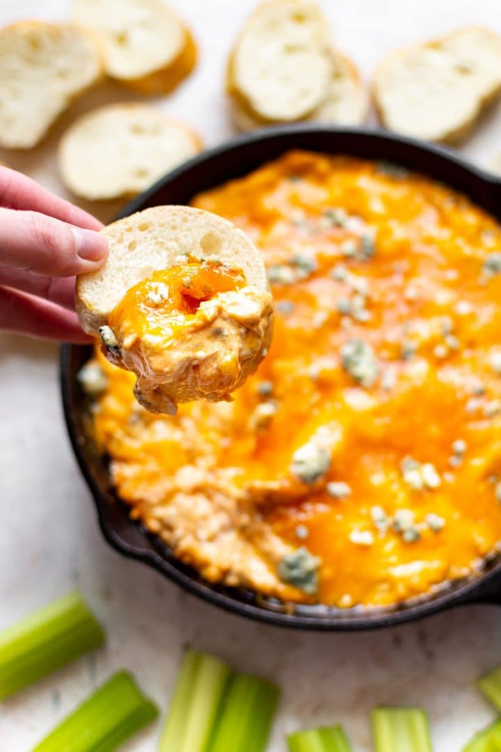 Frank's Red Hot buffalo chicken dip with a baguette scoop and melty cheese