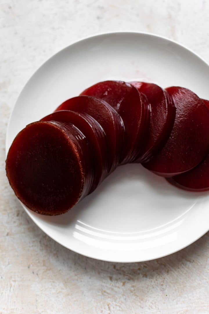 canned cranberry sauce sliced on a white plate