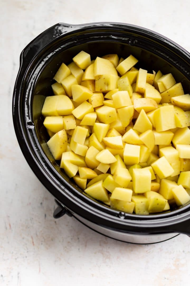 cubed Yukon Gold potatoes in the Crockpot ready to be made into the best mashed potatoes!