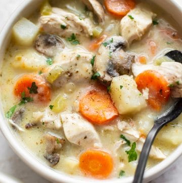 the BEST chicken stew in a bowl with a spoon