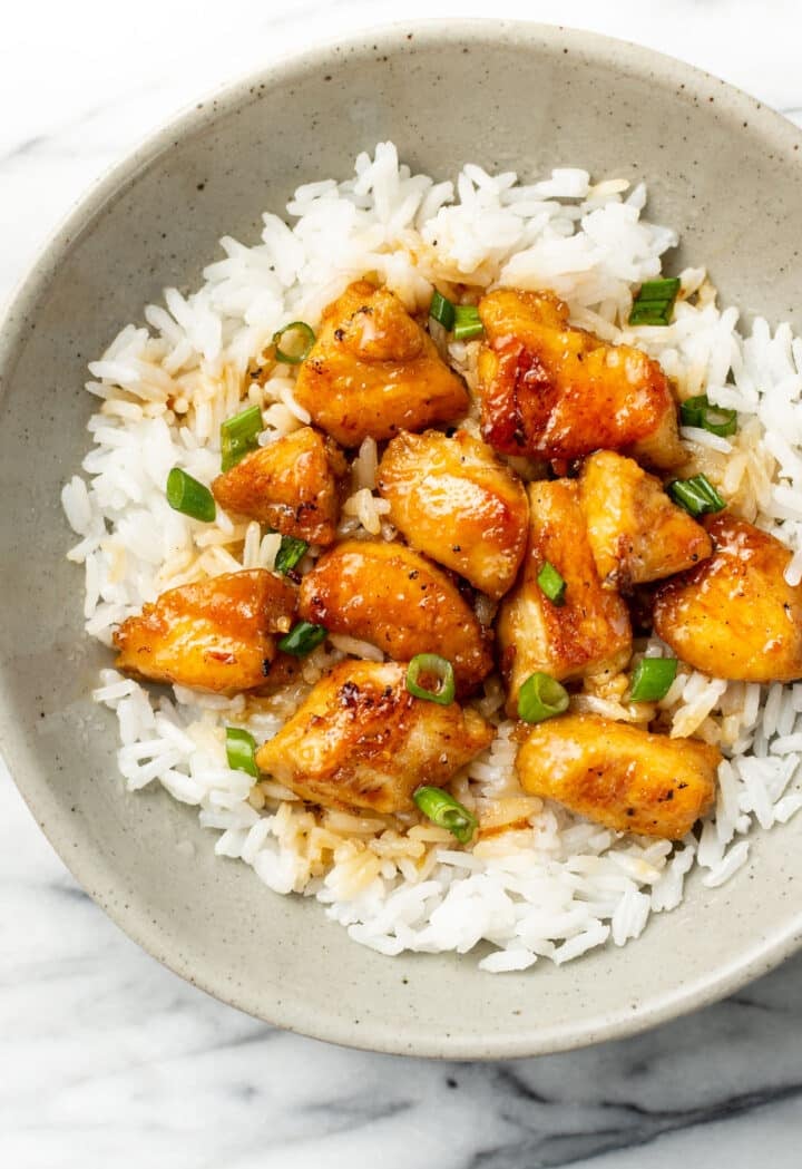 a bowl of honey chicken with jasmine rice