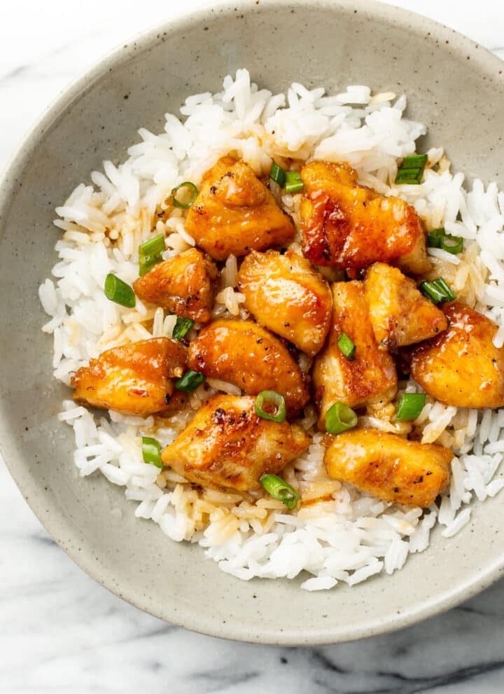a bowl of honey chicken with jasmine rice