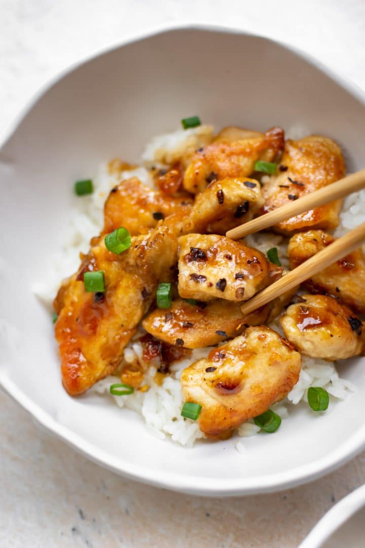 honey chicken in a bowl (close-up with chopsticks)
