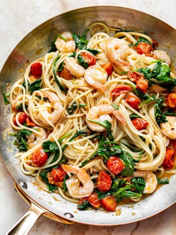 tomato spinach shrimp pasta in a skillet