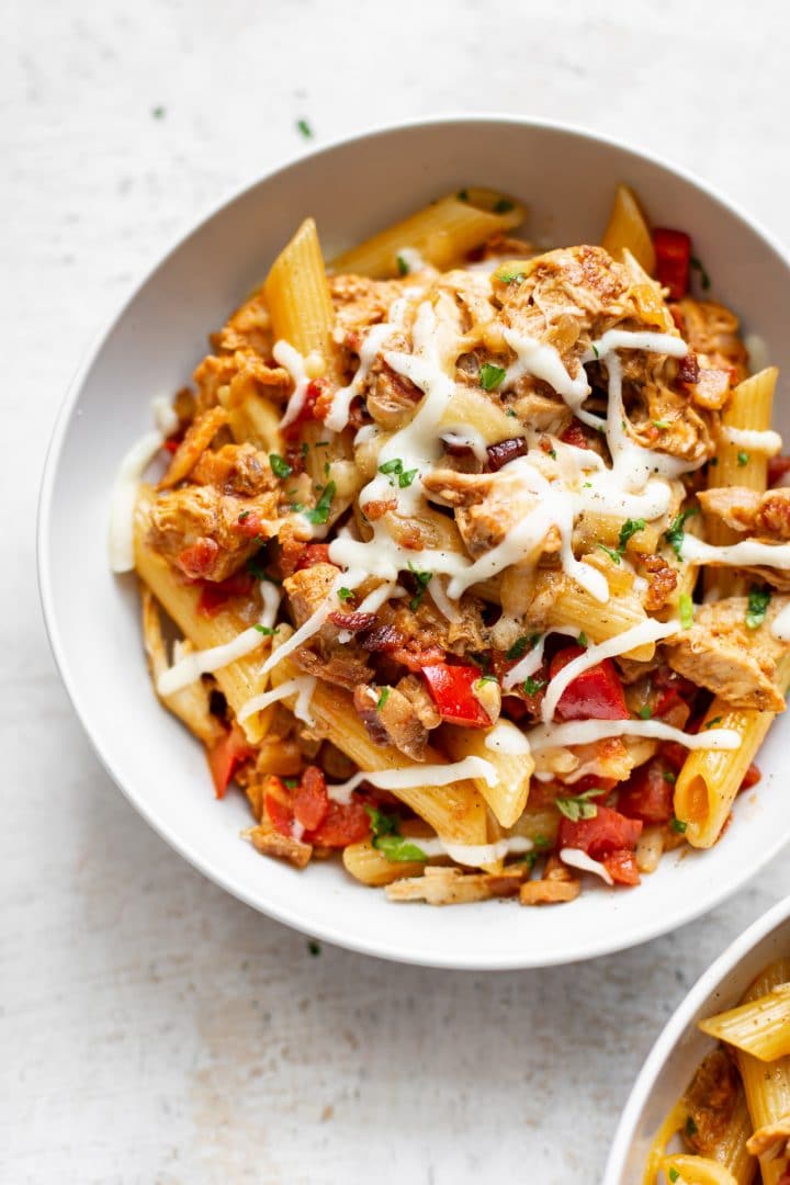 BBQ chicken pasta in two white bowls