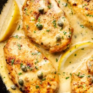 close-up of chicken piccata in a cast iron skillet