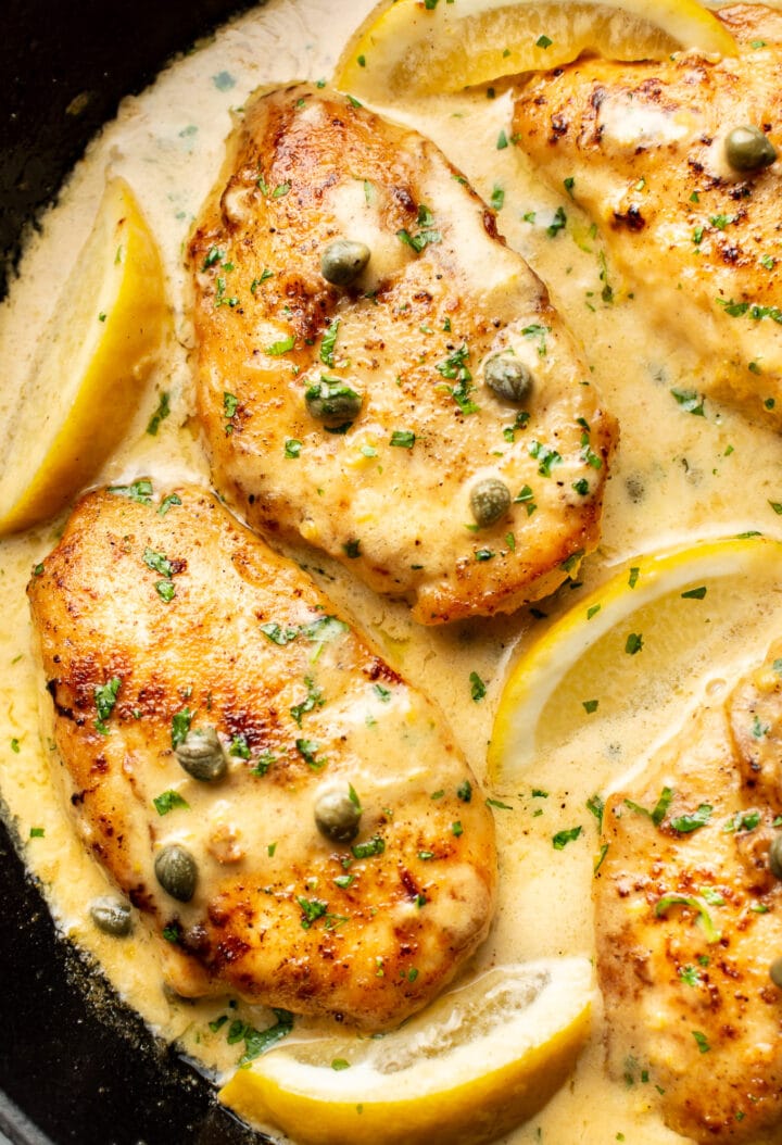 close-up of chicken piccata in a cast iron skillet