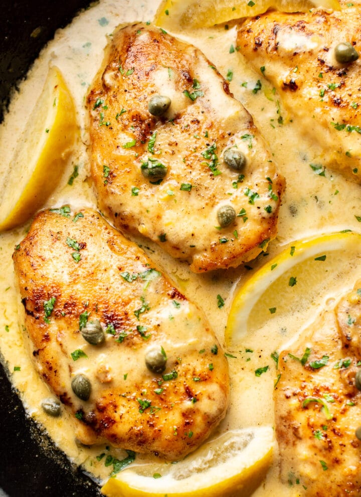 close-up of chicken piccata in a cast iron skillet