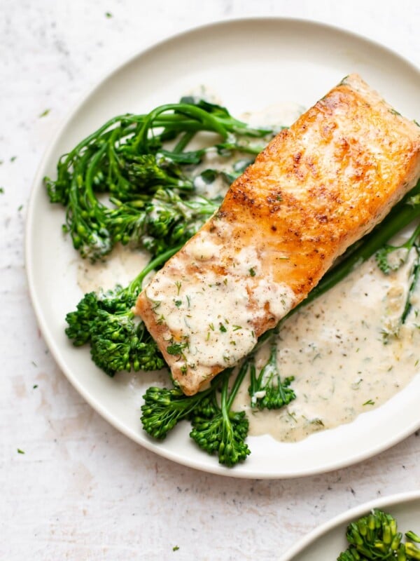 creamy dill salmon plated with broccolini and lots of sauce