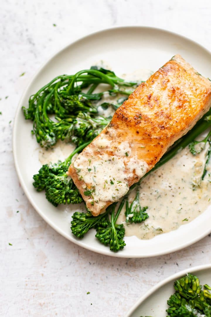 creamy dill salmon plated with broccolini and lots of sauce