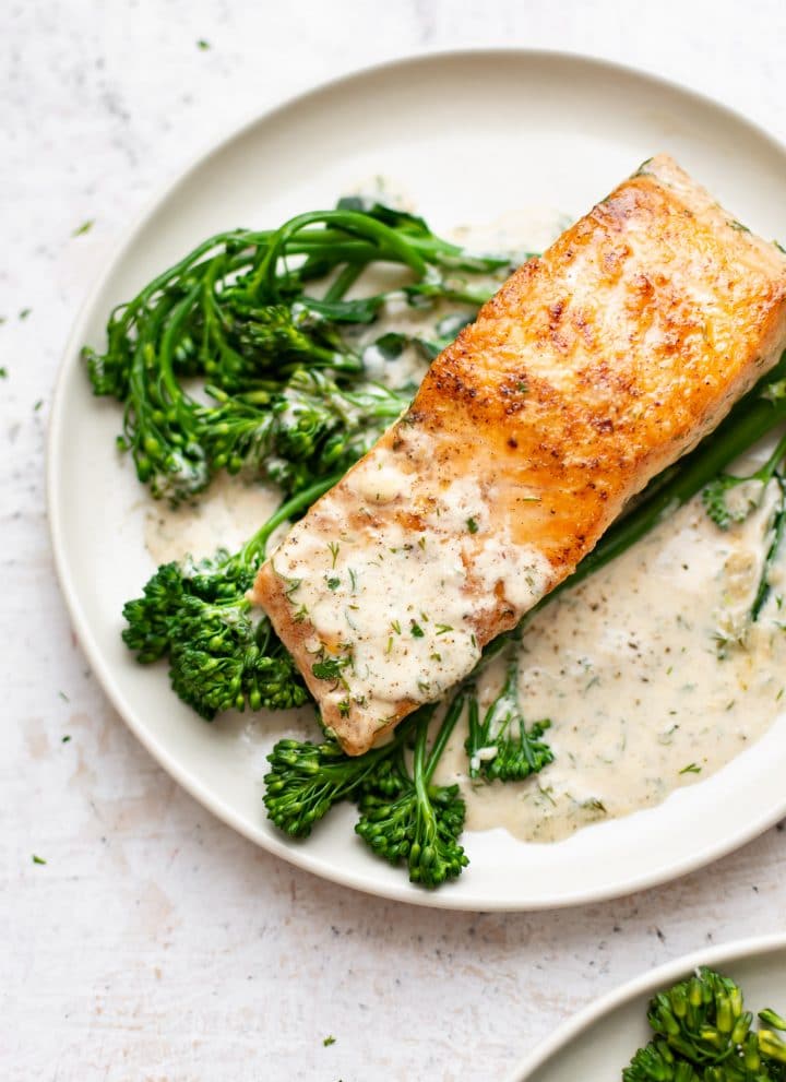 creamy dill salmon plated with broccolini and lots of sauce
