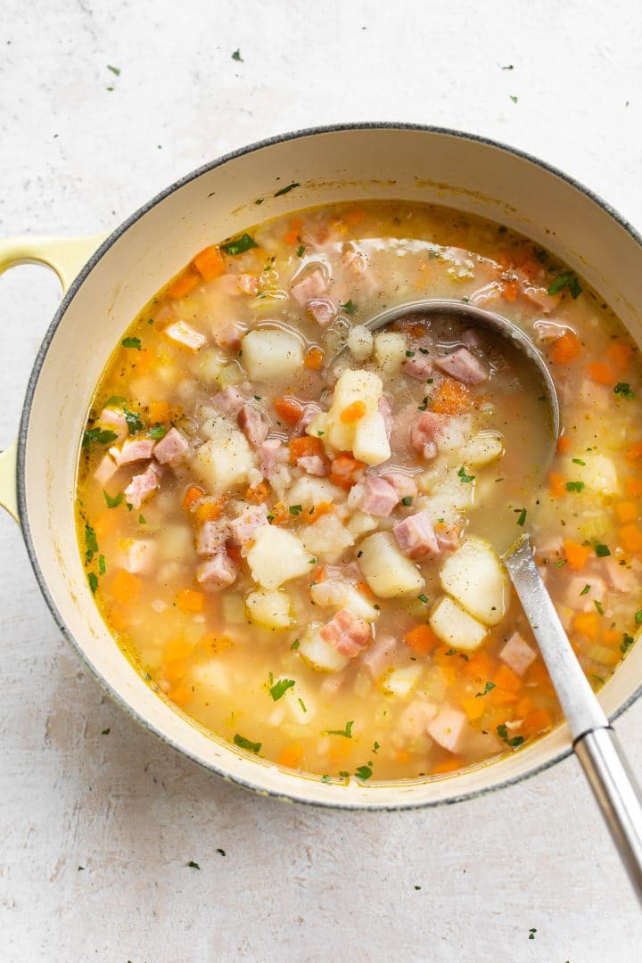 ham and potato soup in a yellow soup pot