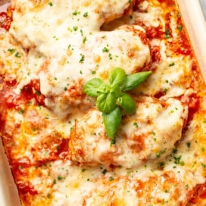 a casserole dish with cheesy mozzarella chicken