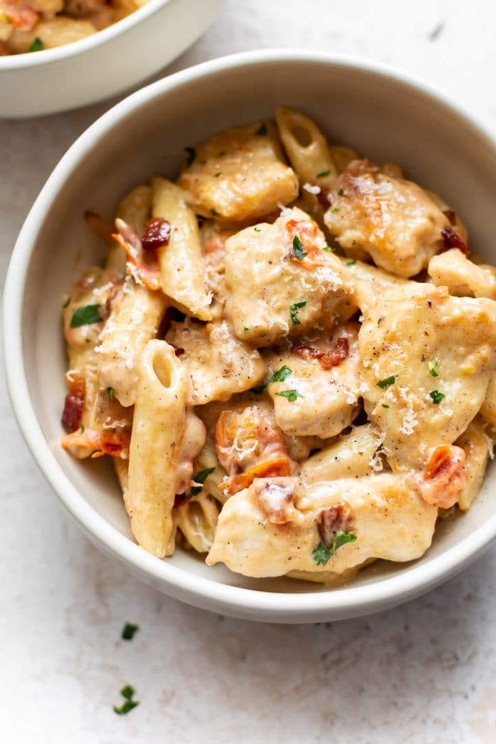 creamy chicken penne pasta in two bowls