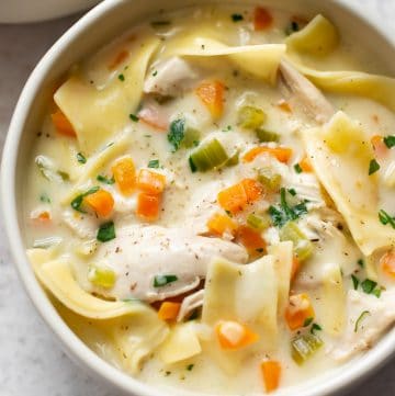 creamy chicken noodle soup with egg noodles, heavy cream, chicken breasts, and vegetables