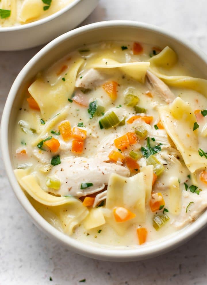 creamy chicken noodle soup with egg noodles, heavy cream, chicken breasts, and vegetables