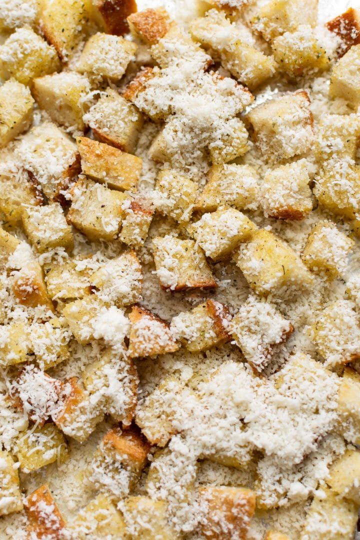 close-up of homemade croutons with freshly grated parmesan sprinkled over top... ready to go in the oven!