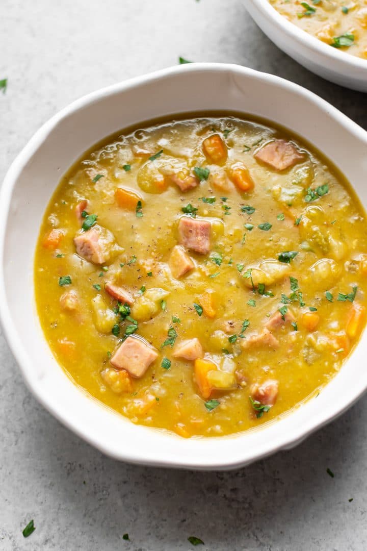 classic split pea soup with ham (in white bowl)